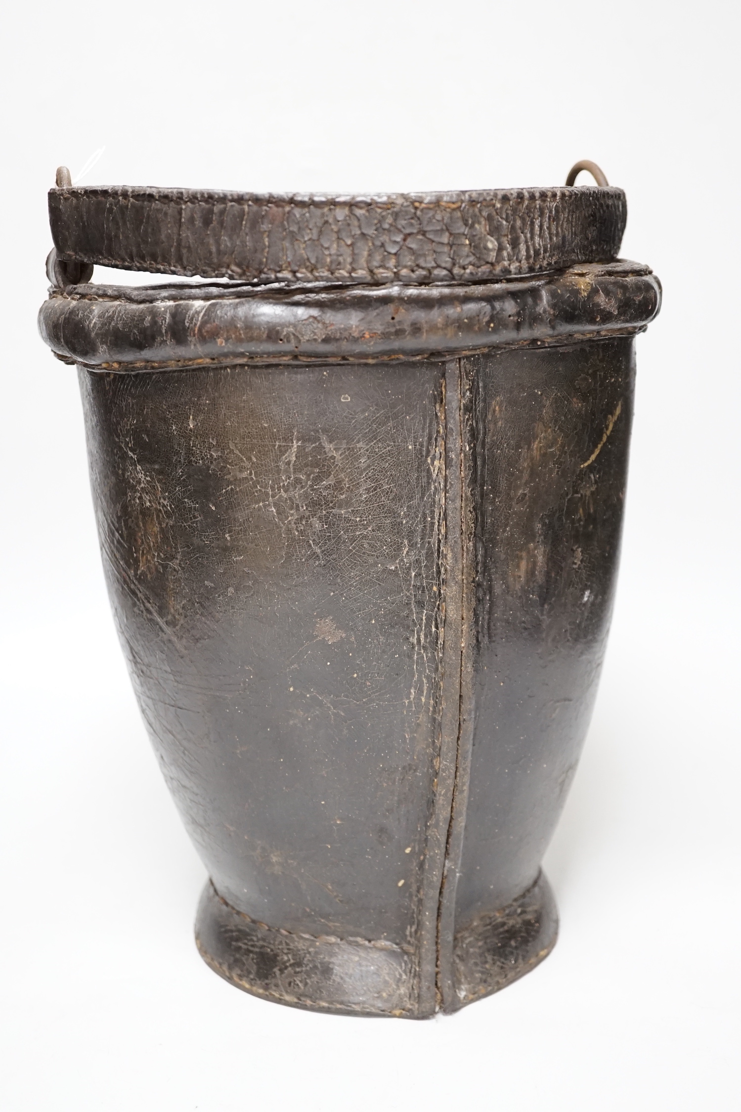 A 19th century leather painted armorial fire bucket, 30cm high